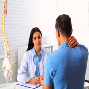 Chiropractor helping a patient that needs chiropractic care